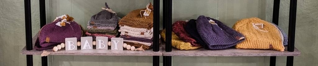 Hand-knitted hats and baby hats in a variety of colors by Laura Kumpula