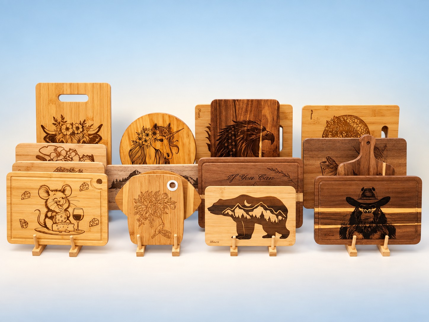 Laser-engraved wood cutting boards with bear, mouse, unicorn, and highland cow designs by Cheryl Travis