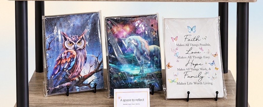 Owl, unicorn, and inspirational faith journals by Mary Francis on display in our 'A Space to Reflect' corner